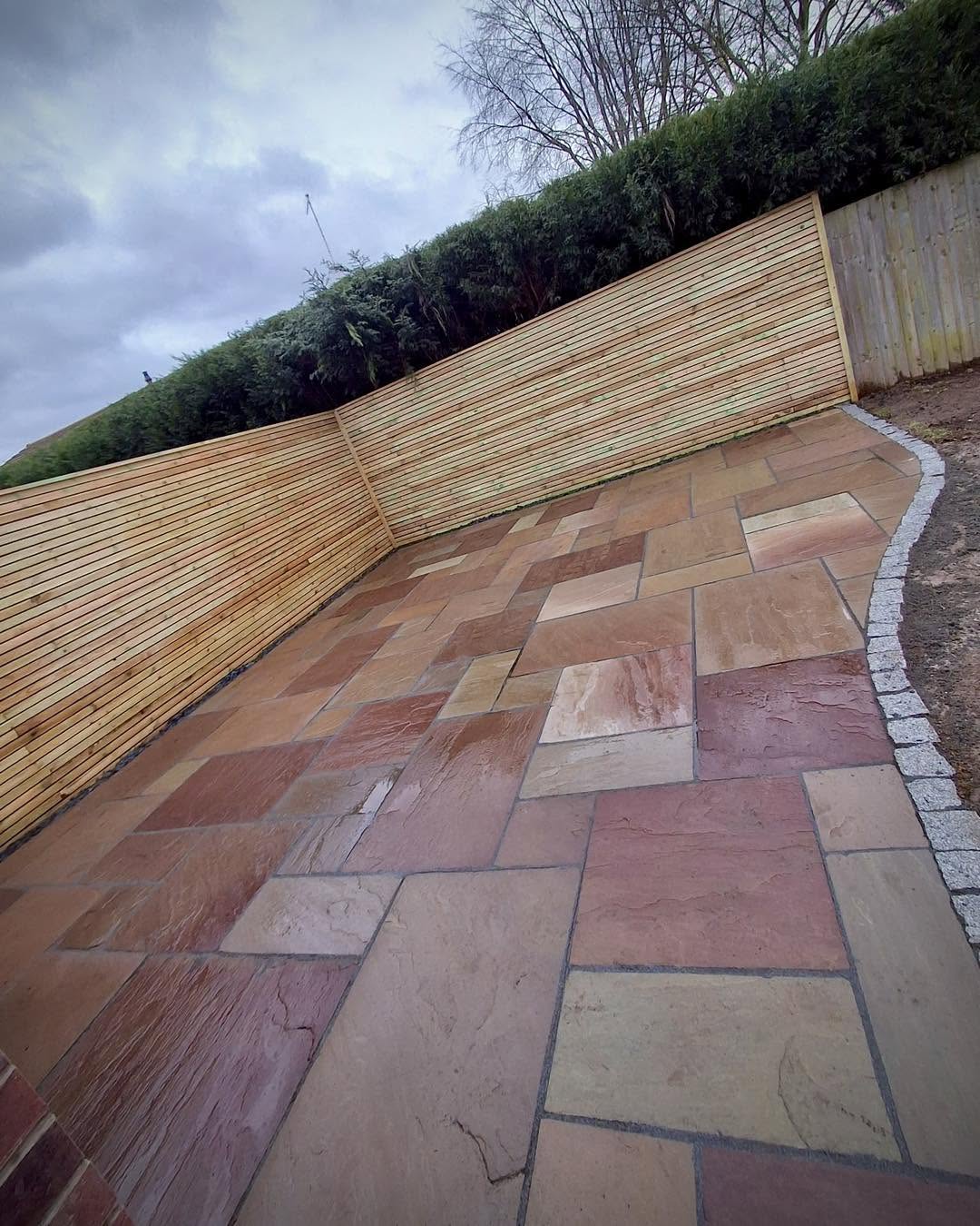 Indian sandstone patio with cedar fencing